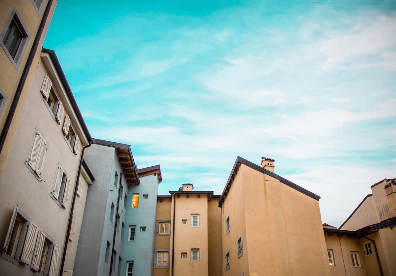 why-choose-us Beautiful view of traditional European architecture with pastel-colored buildings against a clear blue sky.