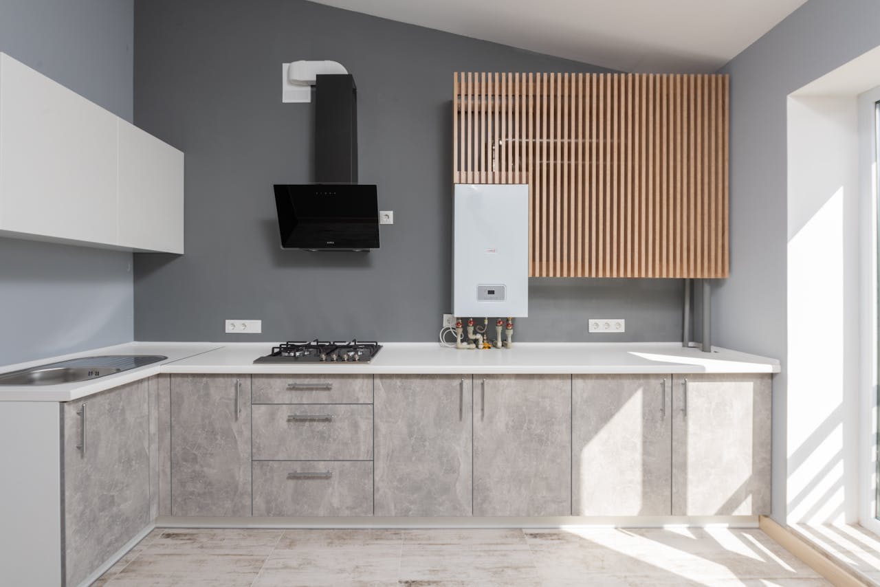 hero-img-02 Bright modern kitchen interior design with appliances and cabinetry.